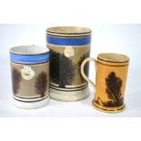 Mocha Ware - a 19th century large tankard, 16.5 cm high and two smaller examples, 12.5 cm & 11.