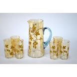 A French iridescent amber ale jug with blue glass handle and six matching tumblers,