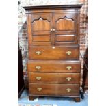 An 18th century and later altered two part Welsh oak food cabinet/chest having a pair of Arabic