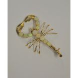 A yellow metal set brooch in the form of a scorpion, the thorax and pedipalps set with opals,