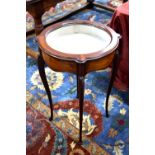 A mahogany vitrine table of circular form,