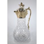 A cut glass claret jug with electroplated collar,