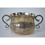 A planished silver Christening porringer with twin scrolling serpent handles, D & J Welby Ltd.