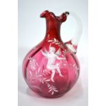 A Victorian cranberry glass ewer decorated in the Mary Gregory style with a cherub, 16.