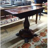 A Regency rosewood fold over card table raised on a multi-facetted tulip form support to a circular
