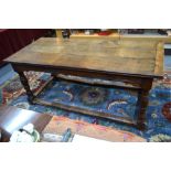 An early 18th century and later oak refectory table,
