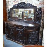 A substantial mirror backed carved oak sideboard in the 18th century style,