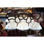 A set of six Victorian mahogany dining/salon side chairs with buttoned overstuffed seats,