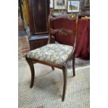 A set of six Regency mahogany dining chairs with shaped and moulded splats, fabric seat pads,