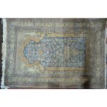 An old silk prayer rug,