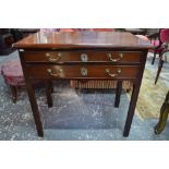An 18th century mahogany side table with two long frieze drawers raised on chamfered square legs,