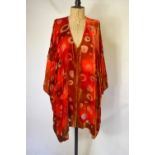 A burnt orange sixty percent silk mix devore jacket with circle design and shaped hem,