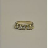 A five stone brilliant cut diamond ring in white metal cast claw setting stamped 14k,