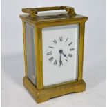 A lacquered brass 8-day carriage clock with white enamelled dial,