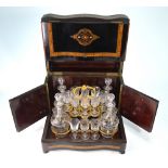 A late 19th century French specimen wood inlaid ebonised travelling liqueur set,