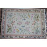 An Aubusson style needlepoint rug, the floral design on beige/cream ground,
