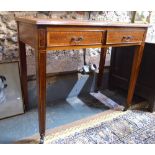 An Edwardian cross banded two drawer side table raised on square tapering legs to brass castors,