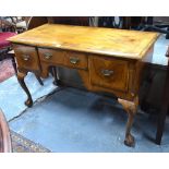 An antique cross-banded yew and elm side table with three frieze drawers,