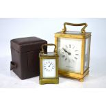 A miniature gilt brass carriage clock with white enamelled dial,