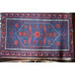 A Turkish rug with geometric design in blue/red,