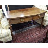 A Victorian mahogany side/serving table, the deep bowfront top over a pair of frieze drawers,