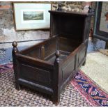 An 18th century oak canopy children's crib of jointed and panelled construction,