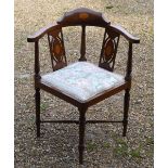 An Edwardian inlaid walnut corner elbow chair with fabric panelled seat