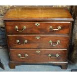 A late 18th century mahogany chest of three long graduated drawers, raised on shaped bracket feet,