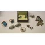 A collection of Native American jewellery including turquoise and enamel-set brooch featuring young