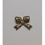 A diamond set stylised bow brooch, yellow gold and silver setting, eight cut and rose diamonds,