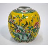 A Chinese yellow ground oviform vase decorated in famille verte style enamels with a bird perched