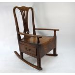 An 18th/19th century oak and elm lambing chair with side drawer to the box seat,