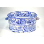 A large oval 19th century blue and white foot bath with shell handles,
