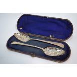 A cased pair of silver berry spoons of Georgian origin with later decoration, 3.