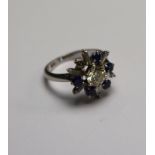 A diamond and sapphire set starburst cluster ring, the central diamond approx 0.