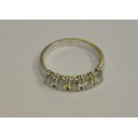 A five stone brilliant cut diamond set ring, white metal set, stamped 750, size J 1/2,