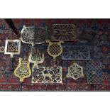 A selection of 19th century brass and iron hearth trivets and small 'footmen' (box)