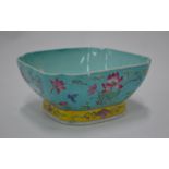 A Chinese famille rose bowl decorated with floral designs; 15 cm wide,