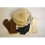 A Canadian white, tipped black, fox fur hat, three pairs of ladies leather gloves,