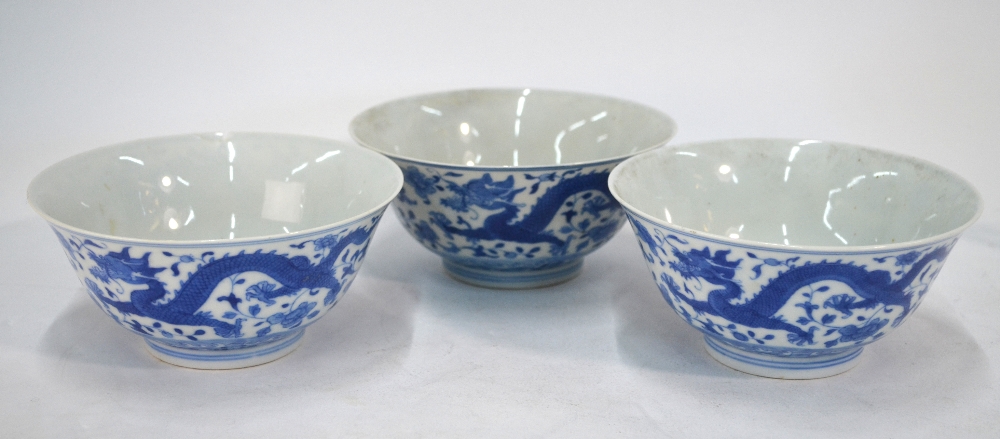 A Chinese set of three blue and white bowls;