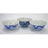 A Chinese set of three blue and white bowls;