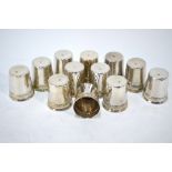 A set of twelve French shot beakers of tapering form with foliate-embossed collars, .