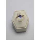 An oval tanzanite ring, 18ct yellow gold set with diamond shoulders in channel setting,