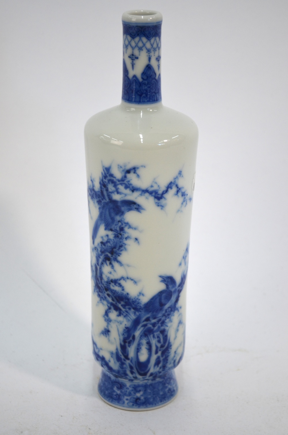 A Chinese blue and white vase with cylindrical neck and tapering body,