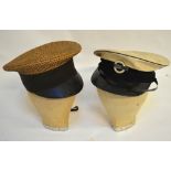 A woven straw peaked cap, a London Transport peaked cap, a grey woollen cap and a green cap,