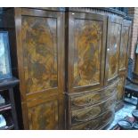 A late 19th/20th century mahogany break-fronted bowfront compactum comprising fitted slides,