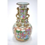 A Chinese Canton famille rose vase with trumpet neck, applied handles of gilded dragon form,