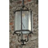 An old Georgian style bronze framed hanging lantern with five serpentine form apertures,
