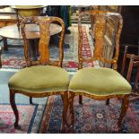 A companion pair of 19th century floral marquetry inlaid walnut side chairs with overstuffed