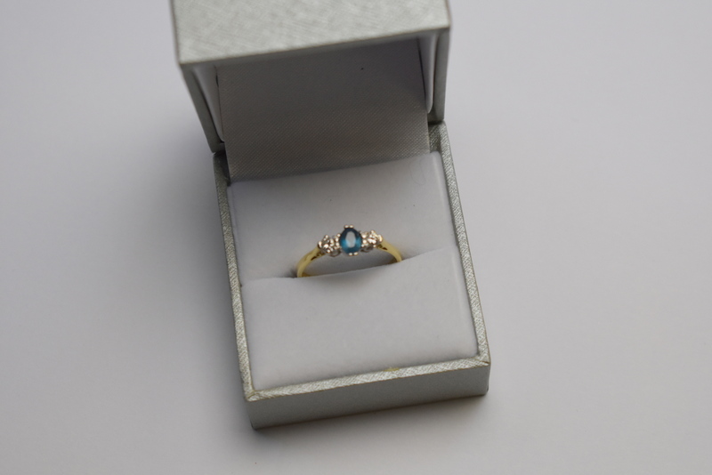 An oval blue topaz and brilliant cut diamond three stone ring, - Image 2 of 2